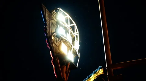 INSECTS FLY AROUND CAROUSEL FLOODLIGHT DURING DARK NIGHT Stock Footage 52396980