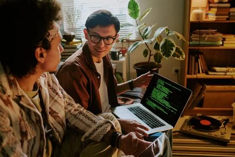 Inseparable Friends Processing Data on Laptop Stock Photos