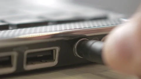 Insert the 3.5 mini jack plug into the laptop Stock Footage 159994327