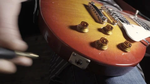 Insert Cable Jack Into Musical Instrument Electric Guitar Stock-Footage 121457482