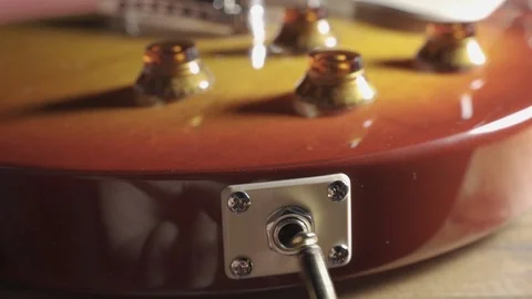 Insert Cable Jack Into Musical Instrument Electric Guitar Stock Footage 121458172