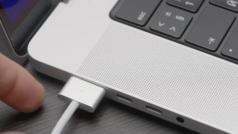 Insert the cable into the laptop. ACTION. Black keyboard in a silver laptop Video stock 181623170