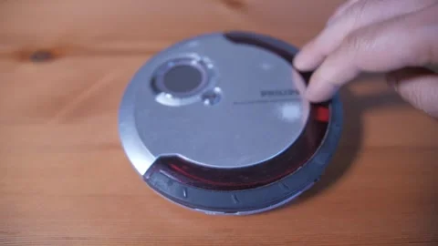 Insert cd into a cd player Stockbeeldmateriaal 289143800