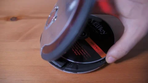 Insert cd into a cd player Stockbeeldmateriaal 289144057