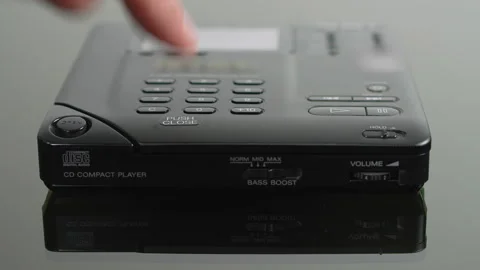 Insert CD in portable cd player, close lid and press play Stock Footage 336396098