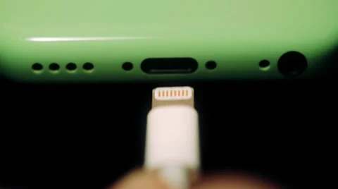 Insert a charging cable into the smartphone Stock Footage 37449533