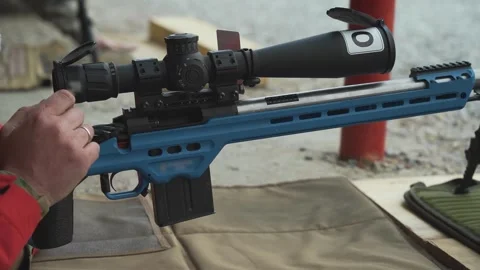 Insert the clip into the sniper rifle and load the weapon Stock Footage 243482872