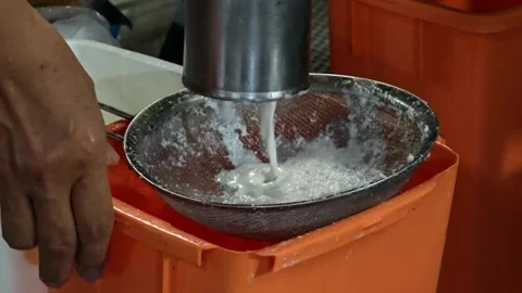 Insert coconut in the coconut grater machine for coconut milk making. Stock Footage 310035659