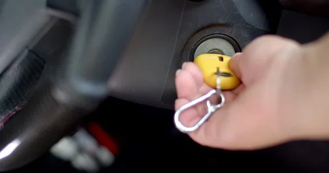 Insert the key and strat engines.Yellow car key. Stock Footage 306396379