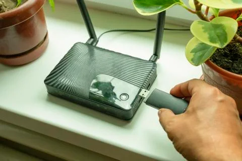 Insert a mobile usb modem into the Internet router on the window sill by the Stock Photos