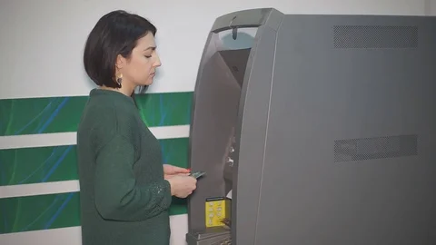 Insert Money into the ATM Stock Footage 72670401