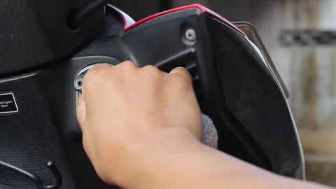 Insert the motorbike key into the keyhole Stock Footage 312479860