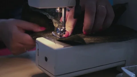 Insert the needle of the sewing machine into the fabric and make a line. 4k Stock Footage 73118350