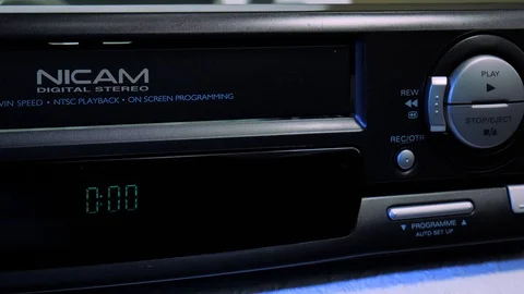 Insert, play, eject an analog VHS video cassette in a recorder VCR 4k Stock Footage 123456758