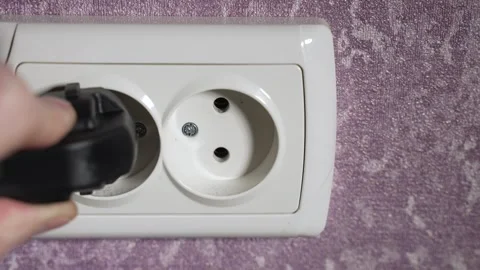 Insert the plug from the electrical appliance into the socket. Slow motion Stock Footage 244662189