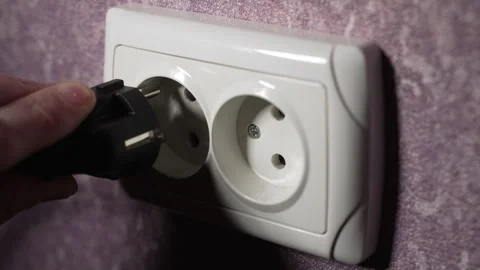 Insert the plug from the electrical appliance into the socket. Slow motion Stock Footage 244662190