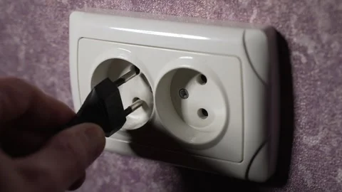 Insert the plug from the electrical appliance into the socket. Slow motion Stock Footage 244662385