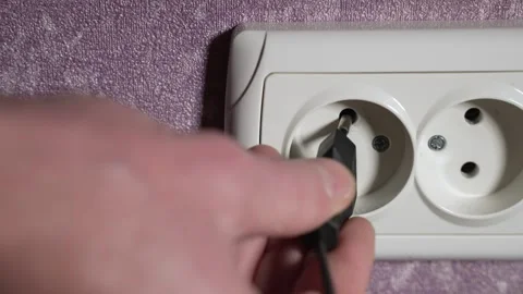 Insert the plug from the electrical appliance into the socket. Slow motion Stock Footage 244662401