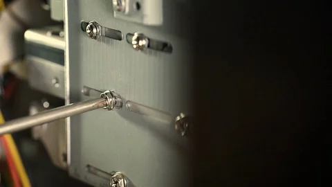 Insert a screw in the cabinet of a computer; server: screw with the screwdriver Stock Footage 78046729