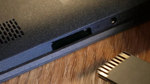 Insert a SD card into the device Stock Footage 73378986