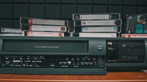 Insert VHS Cassette into VCR and Push Play Button Stock Footage 177873476