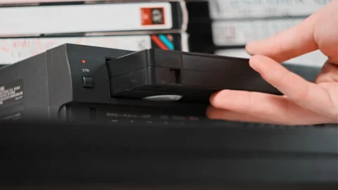 Insert VHS Cassette into VCR Player | Stock Video | Pond5