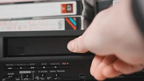 Insert VHS Cassette into VCR Player | Stock Video | Pond5
