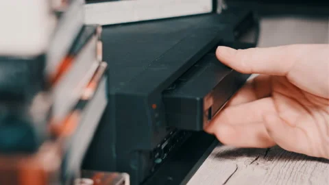 Insert VHS Cassette Into VCR Video Player Stock Footage 234444799