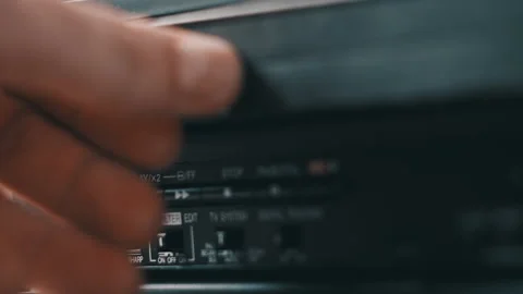 Insert VHS Cassette Into VCR Video Player Video stock 234607832
