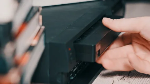 Insert VHS Cassette Into VCR Video Player Stock Footage 235912224