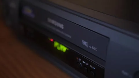Insert video vhs cassette into video recorder 4k Stock Footage 281868287