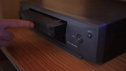 Insert video vhs cassette into video recorder 4k Video stock 281868567