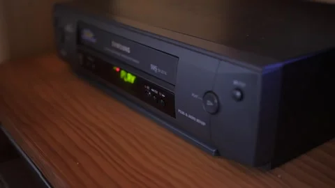 Insert video vhs cassette into video recorder 4k Stock Footage 281868810