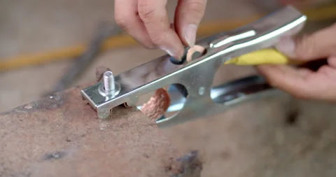 Insert the wires into the welding clamps after completing the crimping. Stock Footage 311092728
