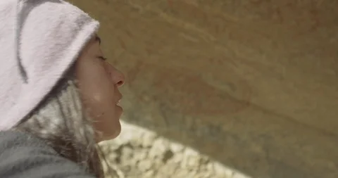 Insert of woman looking at cave paintings Stock Footage 90405262