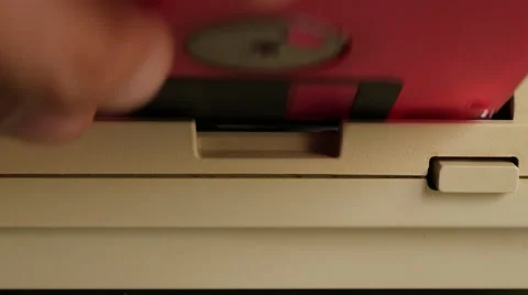 Inserting 3.5 inch  floppy disk in retro personal computer 4K 2160p 30fps Ult Stock Footage 56240624