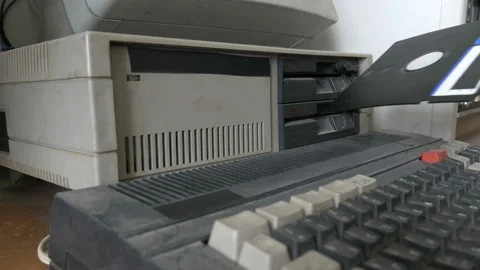Inserting the 5.25 Inch floppy disk in outdated computer. Old pc 1980s - 1990s 스톡 동영상 91373978