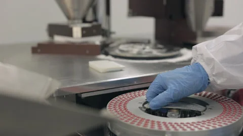 Inserting Capsule Rotary Disc Tray into Encapsulation Machine Stock Footage 68643037