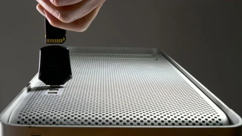 Inserting card reader into desktop computer, followed by SD card. Stock-Footage 142268216