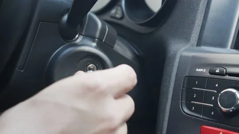Inserting cars key into engine start switch 4K video Stock Footage 160749011