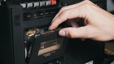 Inserting Cassette Tape into Vintage Stereo Recorder Video stock 317762774