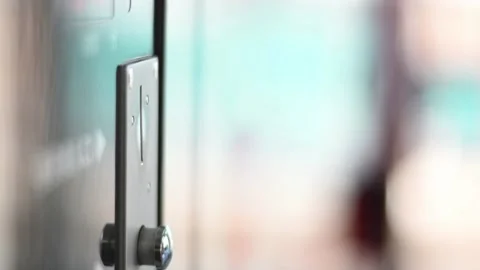 Inserting a coin into a coin machine using 100 Japanese Yen coins Stock Footage 252729272