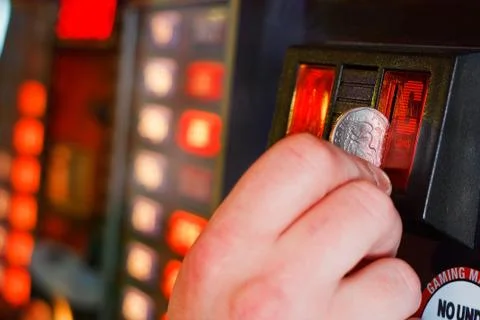Inserting coins into gaming machine Stock Photos