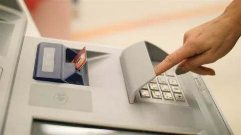 Inserting credit card in atm machine and dialing pin numbers to withdraw money Stock Footage 52329456