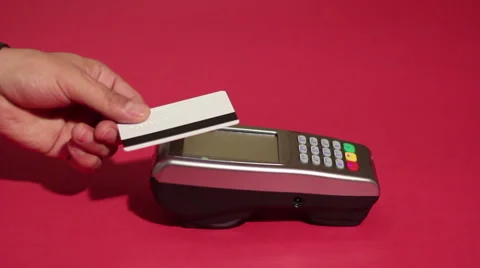 Inserting credit card into card machine and dialing pin code on red background. Stock Footage 65396548