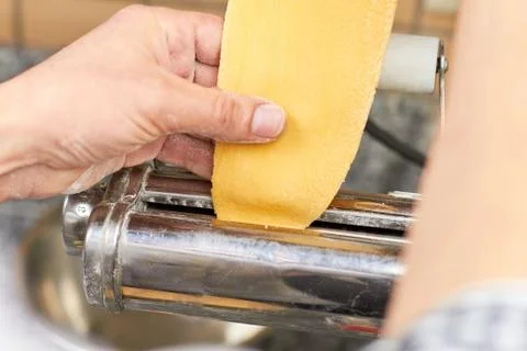Inserting dough into dough sheeter. Stock Photos