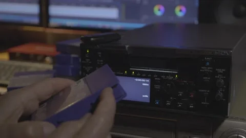 Inserting DVcam video tape into professional video recorder. Editing studio. 库存影片 151132770