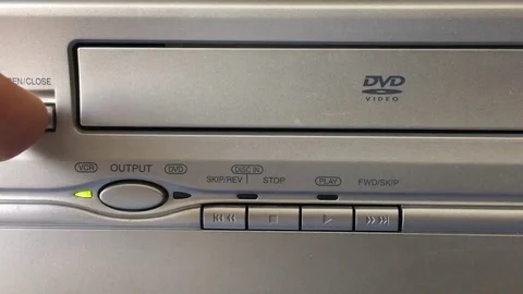 Inserting DVD into Player Close Up Stockbeeldmateriaal 79226740