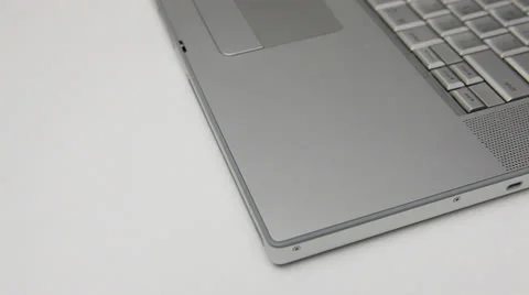 Inserting a dvd into a silver laptop Stock Footage 22480790