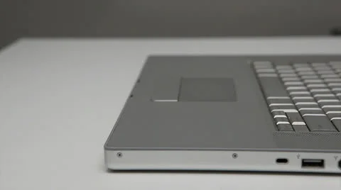 Inserting a dvd into a silver laptop Stock Footage 22481618